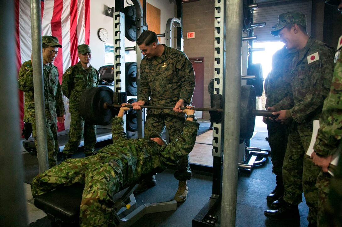 Japan Ground Self-Defense Force (JGSDF) and U.S. Marines with 1st Reconnaissance Bn., 1st Marine Division take a break during training to lift weights at Camp Pendleton, Calif., Jan. 26, 2016. The JGSDF and Marines are conducting Exercise Iron Fist 2016, an annual bilateral amphibious training exercise. The U.S.-Japan Alliance has been the foundation of peace and security in Northeast Asia and cornerstone of U.S. engagement in the region. (U.S. Marine Corps photo by Cpl. Xzavior T. McNeal/Released)