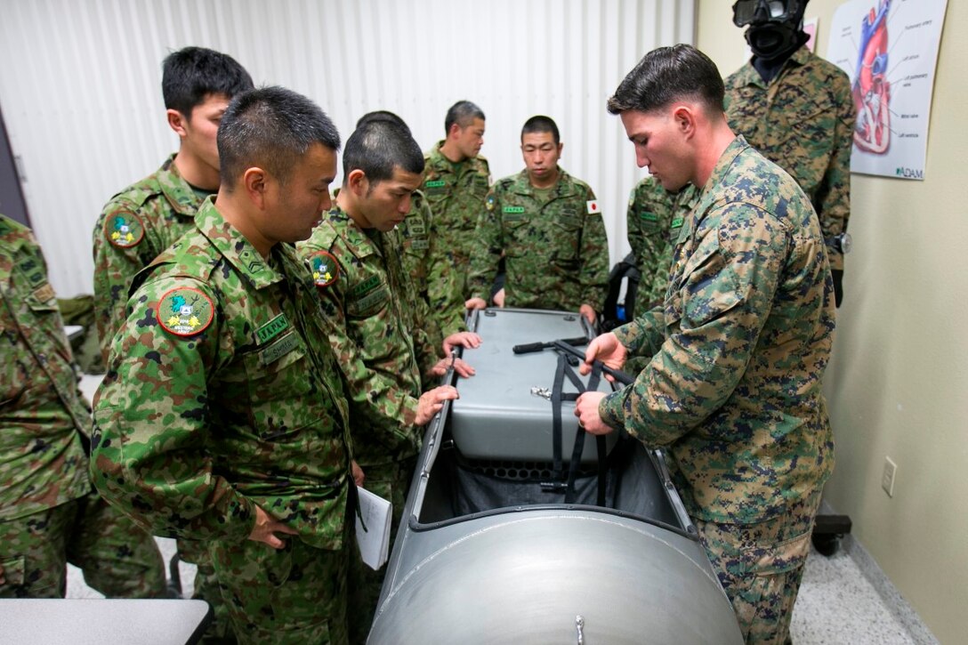 Sergeant James Chirdo, a reconnaissance man with 1st Reconnaissance Bn., 1st Marine Division, demonstrates proper employment of the diver propulsion device (DPD) to soldiers with the Japan Ground Self-Defense Force (JGSDF), Western Army Infantry Regiment, during Exercise Iron Fist 2016 aboard Camp Pendleton, Calif., Jan. 26. The DPD provides divers with expedient underwater travel. (U.S. Marine Corps photo by Cpl. Xzavior T. McNeal/Released)