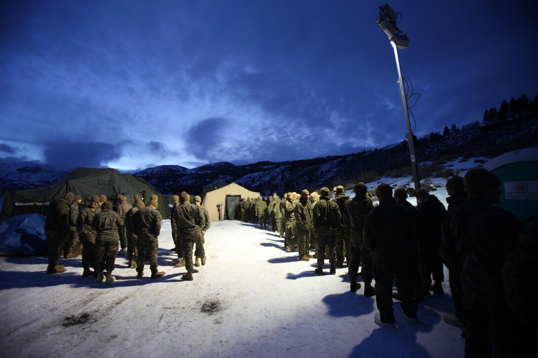 Hundreds of Marines wait to enter the field mess tent for hot food during cold weather training at the Marine Corps Mountain Warfare Training Center, Calif., Jan. 10, 2015. Hundreds of Marines participated in the cold weather training, enduring freezing temperatures during the two-week-long exercise in the Sierra Mountains. (U.S. Marine Corps photo by Cpl. Jason Jimenez/Released)