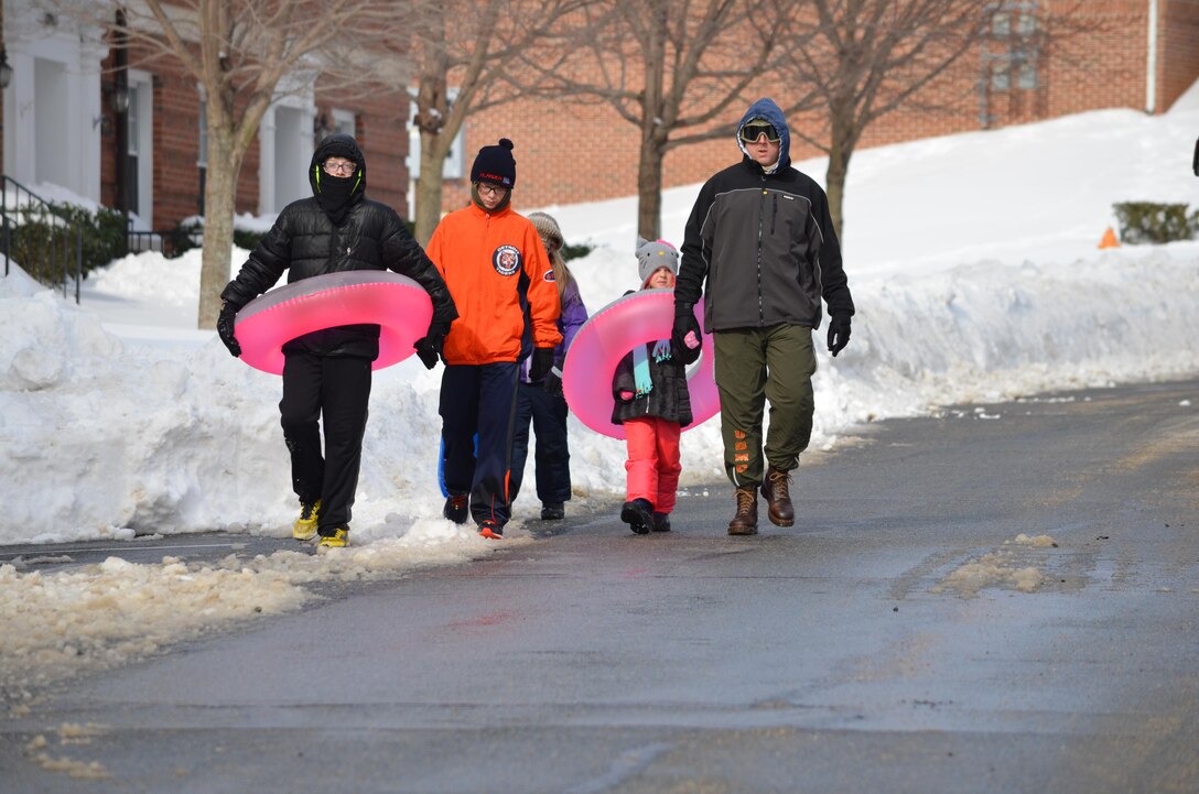Sebastian, 12; Sean, 12, Sophia, 6; and Maj. Tim Zelek are making the trek from home to Butler Stadium to go tubing and sledding on Monday, a day that all had off from school and work.