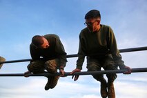 Staff Sgt. James Case (left), the chief instructor of the Headquarters Battalion, 1st Marine Division Lance Corporal Leadership and Ethics Seminar, helps a seminar student through a portion of the obstacle course during a combat conditioning session aboard Marine Corps Base Camp Pendleton, Calif., Jan. 27, 2016. The week-long seminar focuses on preparing lance corporals physically and mentally to become successful noncommissioned officers, while building the foundation for the more difficult residential courses like Corporals Course and Sergeants Course.