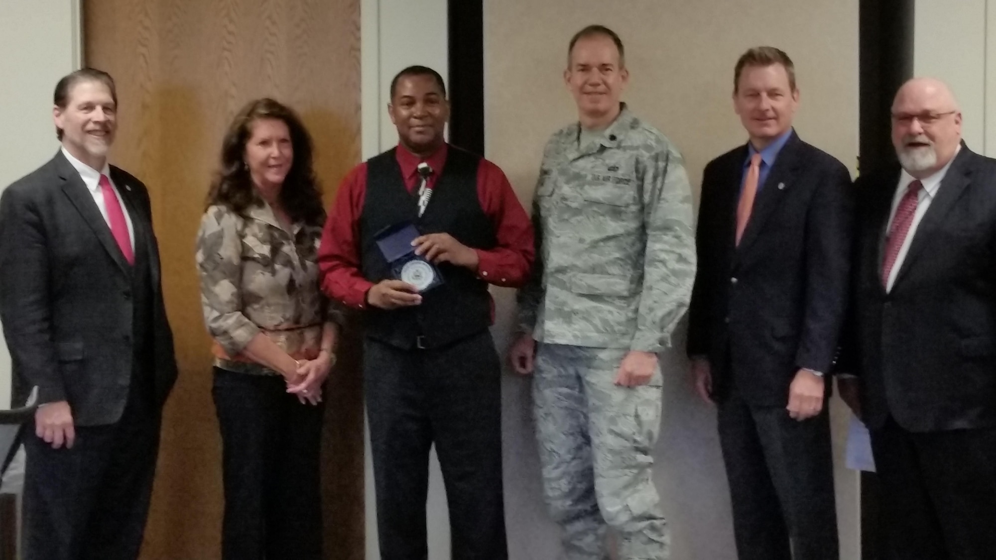 Ric Nunerley, Air Reserve Personnel Center administrative support specialist, stands next to Lt. Col. Bruce Winhold, ARPC process manager, after receiving a Wonderful Outstanding Worker Award during the Colorado Federal Executive Board quarterly meeting and breakfast Jan. 28, 2016, in Denver. (U.S. Air Force photo/Mark Nelson)