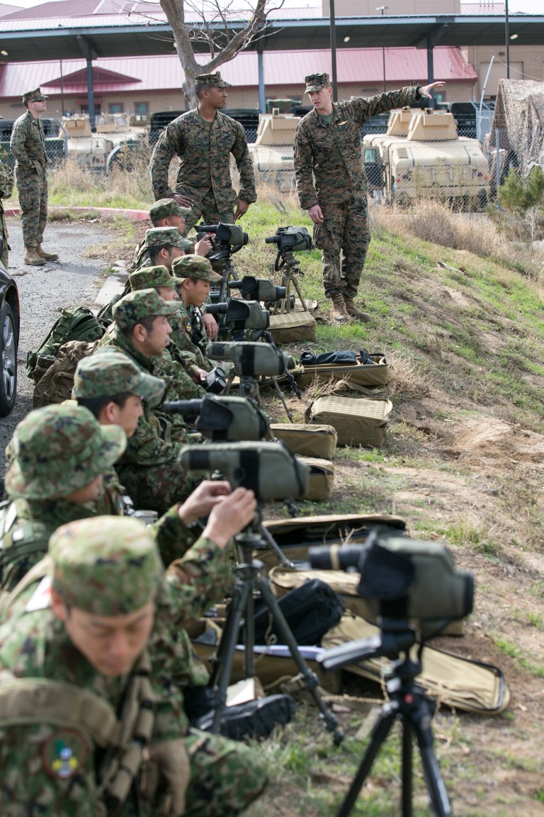 Staff Sgt. Mark Pins, right, a reconnaissance man with 1st Reconnaissance Bn., 1st Marine Division, and Staff Sgt. Shaun Bevett, left, an interpreter assigned to 11th Marine Expeditionary Unit (MEU), position Japan Ground Self-Defense Force (JGSDF) soldiers in an observation line for vector binocular training for Exercise Iron Fist 2016 aboard Camp Pendleton, Calif., Jan. 27. Vector binoculars are used to gather distance and direction via laser application and provide long distance observation capabilities. (U.S. Marine Corps photo by Cpl. Xzavior T. McNeal/Released)