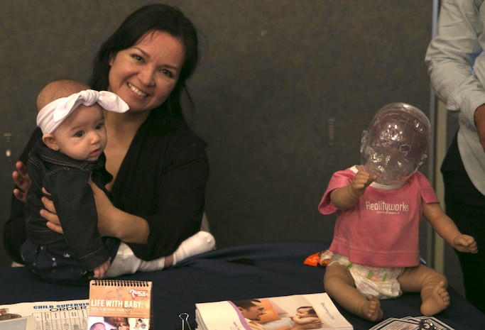 Liz Garcia, New Parent Support Program home visitor, provides new parents with information on the program and how to care for their child at the 4th Annual Baby Expo at Marine Corps Air Station Iwakuni, Japan, Jan. 23, 2016. Families found information like this and more at the expo to guide them into parenthood.