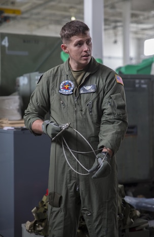 Sgt. Chris McClellan, KC-130J Super Hercules crew master with Marine Aerial Refueler Transport Squadron (VMGR) 152 at Marine Corps Air Station Iwakuni, Japan, discusses proper inspection of Y-cables prior to their use in an air drop kit, Jan. 26, 2016. McClellan taught a handful of crew masters and students the importance of gear check inspections while reviewing the nomenclature and uses of equipment in an air drop kit.