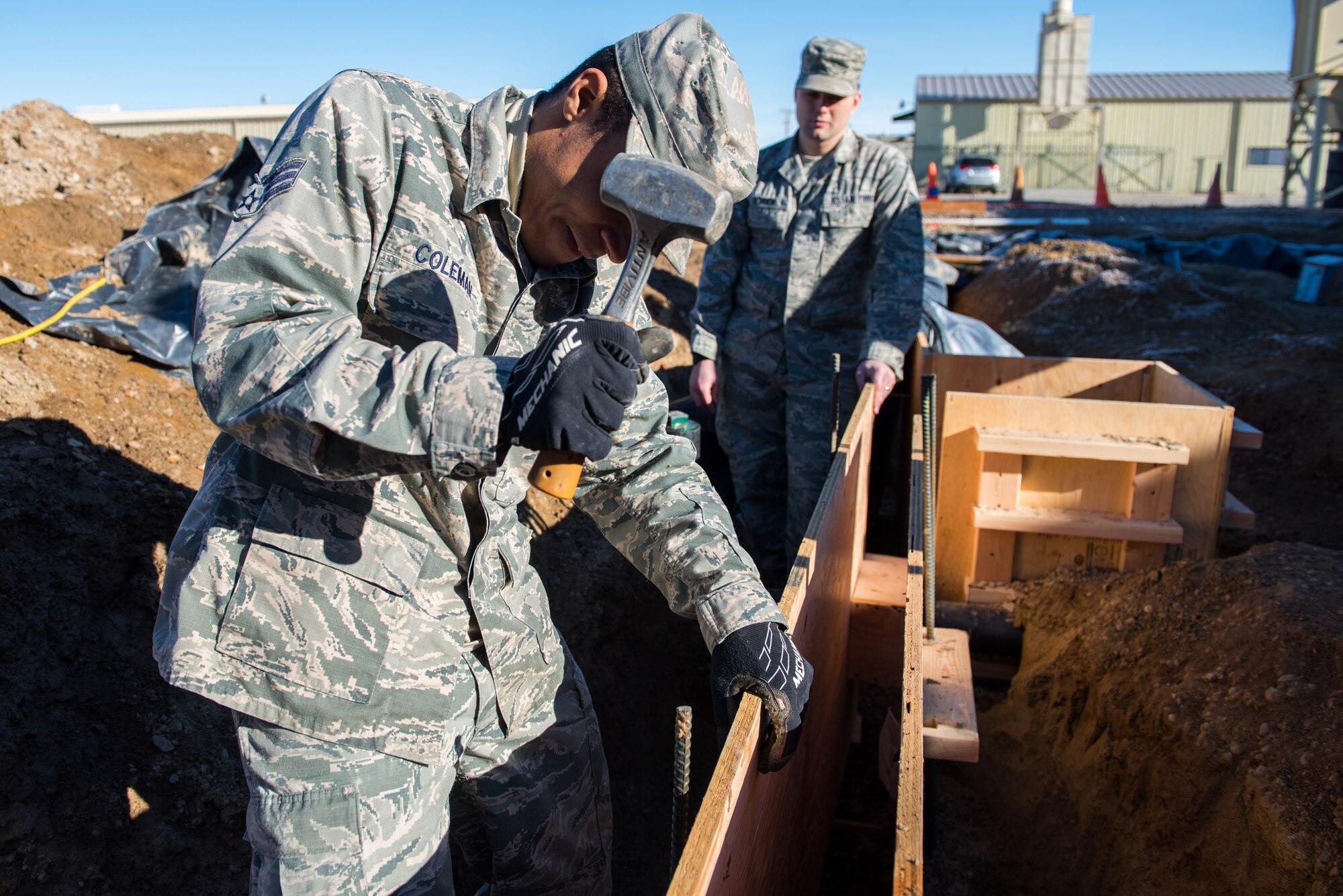 Senior Airman Nathan Coleman, 366th Civil Engineer Squadron structures specialist, drives rebar into the ground, Jan. 25, 2016, at Mountain Home Air Force Base, Idaho. The boards held together by the rebar will form a concrete base for the 1400 square foot building the engineers are building. (U.S. Air Force photo by Airman 1st Class Connor J. Marth/RELEASED)