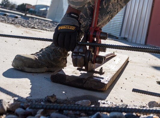 Senior Airman Jaylon Gordon, 366th Civil Engineer Squadron heating ventilation and air conditioning specialist, cuts rebar, Jan. 25, 2016, at Mountain Home Air Force Base, Idaho. The building Gordon is helping construct is part of the annual Troop Training Project used to prepare airmen for future tasks and deployments. (U.S. Air Force photo by Airman 1st Class Connor J. Marth/RELEASED)