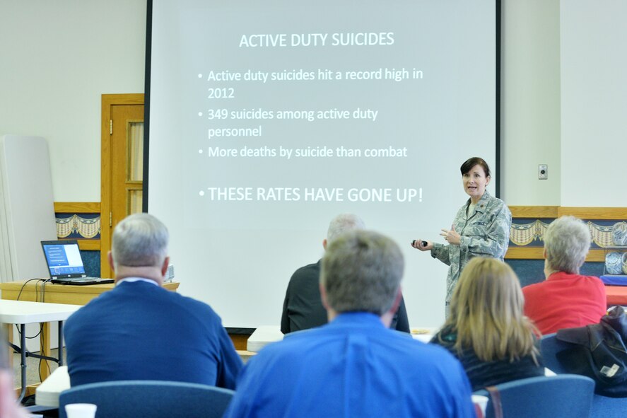 U.S. Air Force Maj. Shauna Crim, 55th Medical Operations Squadron mental health flight commander, speaks to a crowd filled with local pastors and other representatives from various state departments during a Suicide Awareness and Intervention Training event at the SAC chapel on Offutt AFB, Neb., Nov. 10, 2015. According to the U.S. Department of Veteran Affairs, 22 veterans commit suicide every day.