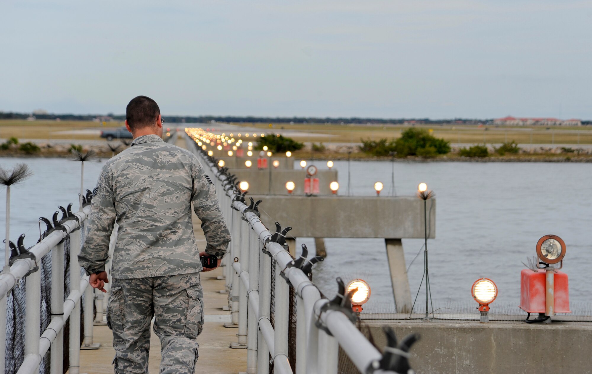 Staff Sgt. Michael David, an airfield management operations supervisor with the 6th Operations Support Squadron, inspects the sequenced flashing lights used for aircraft landing at MacDill Air Force Base, Fla., Jan. 22, 2016. Airfield management Airmen are responsible for performing multiple daily airfield checks to ensure the it is safe for aircraft. (U.S. Air Force photo by Airman 1st Class Mariette M. Adams)