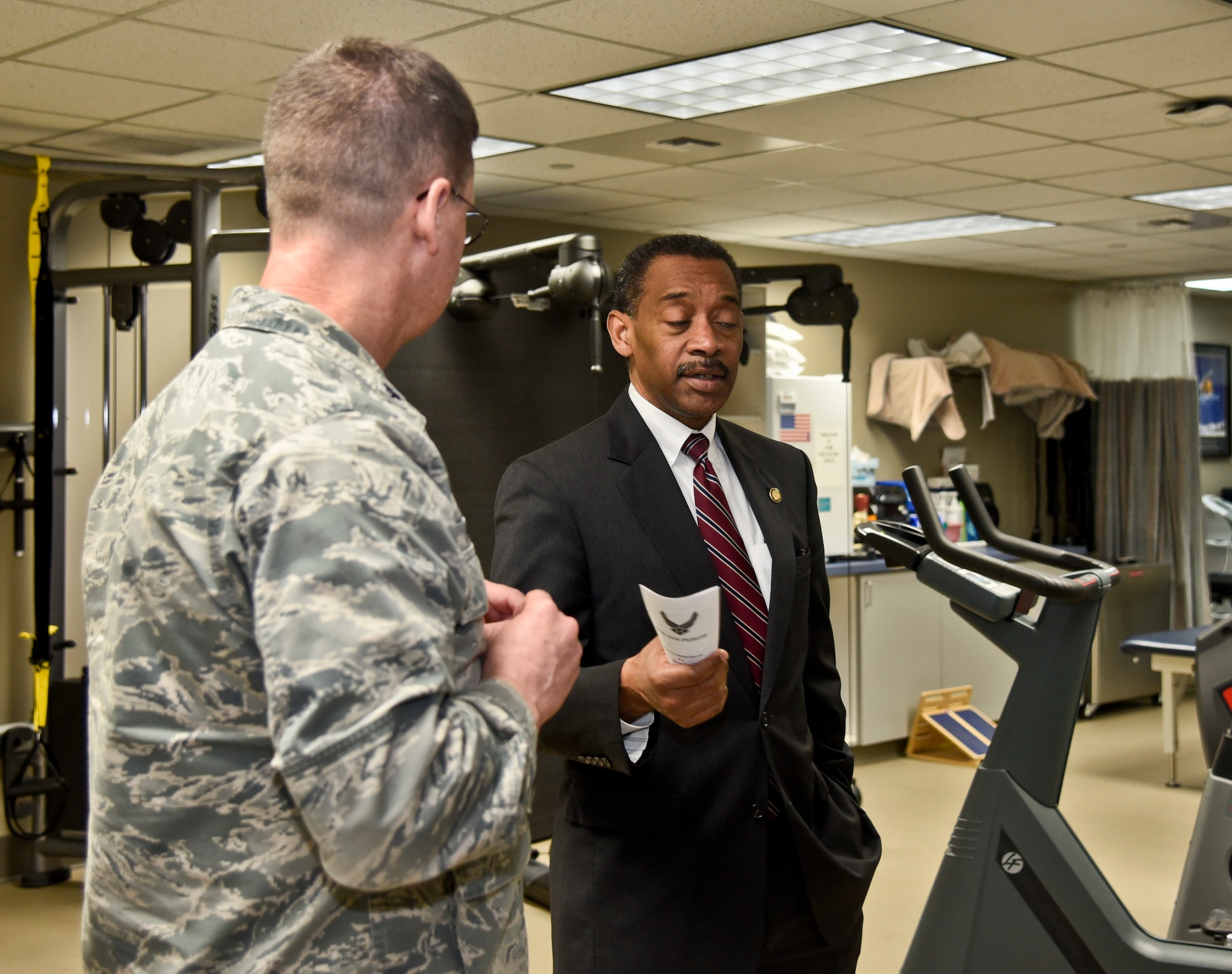 Dr. Jonathan Woodson, Assistant Secretary of Defense for Health Affairs, speaks with Lt. Col. Troy McGill, 92nd Medical Operations Squadron physical therapy flight commander, about the new Electronic Health Records program during a tour Jan. 15, 2016, at Fairchild Air Force Base, Wash. Fairchild staff will be testing and training on the new program over the next year and will begin utilizing it as the official 92nd Medical Group patient record in December. (U.S. Air Force photo/Airman 1st Class Taylor Bourgeous)