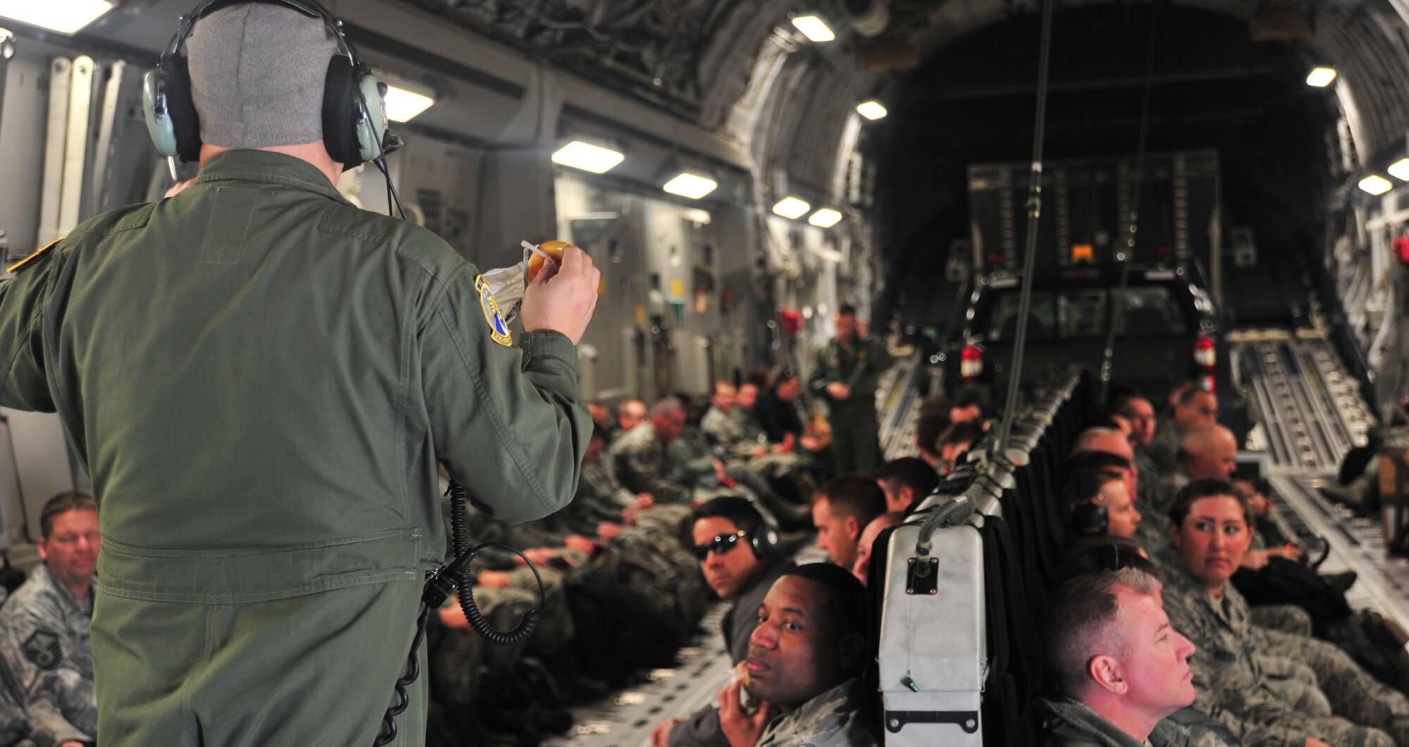 U.S. Air Force Tech. Sgt. Eric Baldoni, a loadmaster assigned to the 300th Airlift Squadron at Joint Base Charleston, S.C., gives a safety brief to members of the 442d Fighter Wing before takeoff at Whiteman Air Force Base, Mo., Jan. 24, 2016. The brief covered actions to take in case of an in-flight emergency while en route to Patrick Air Force Base, Fl., for a multi-week joint combat search and rescue exercise. (U.S. Air Force photo by Airman 1st Class Jovan Banks)