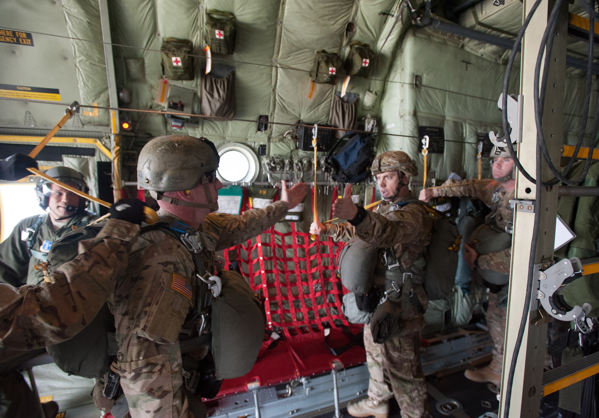 A jumpmaster assigned to the 7th Special Forces Group (Airborne), left, receives the “All Okay Jumpmaster!” from a fellow jumper, signaling each soldier in the chalk is prepared to conduct a static line parachute jump.  Soldiers and Green Berets from the group conducted the airborne operation Jan. 12 to maintain their proficiency at airborne insertions.  (U.S. Air Force photo/Staff Sgt. William Waller)

