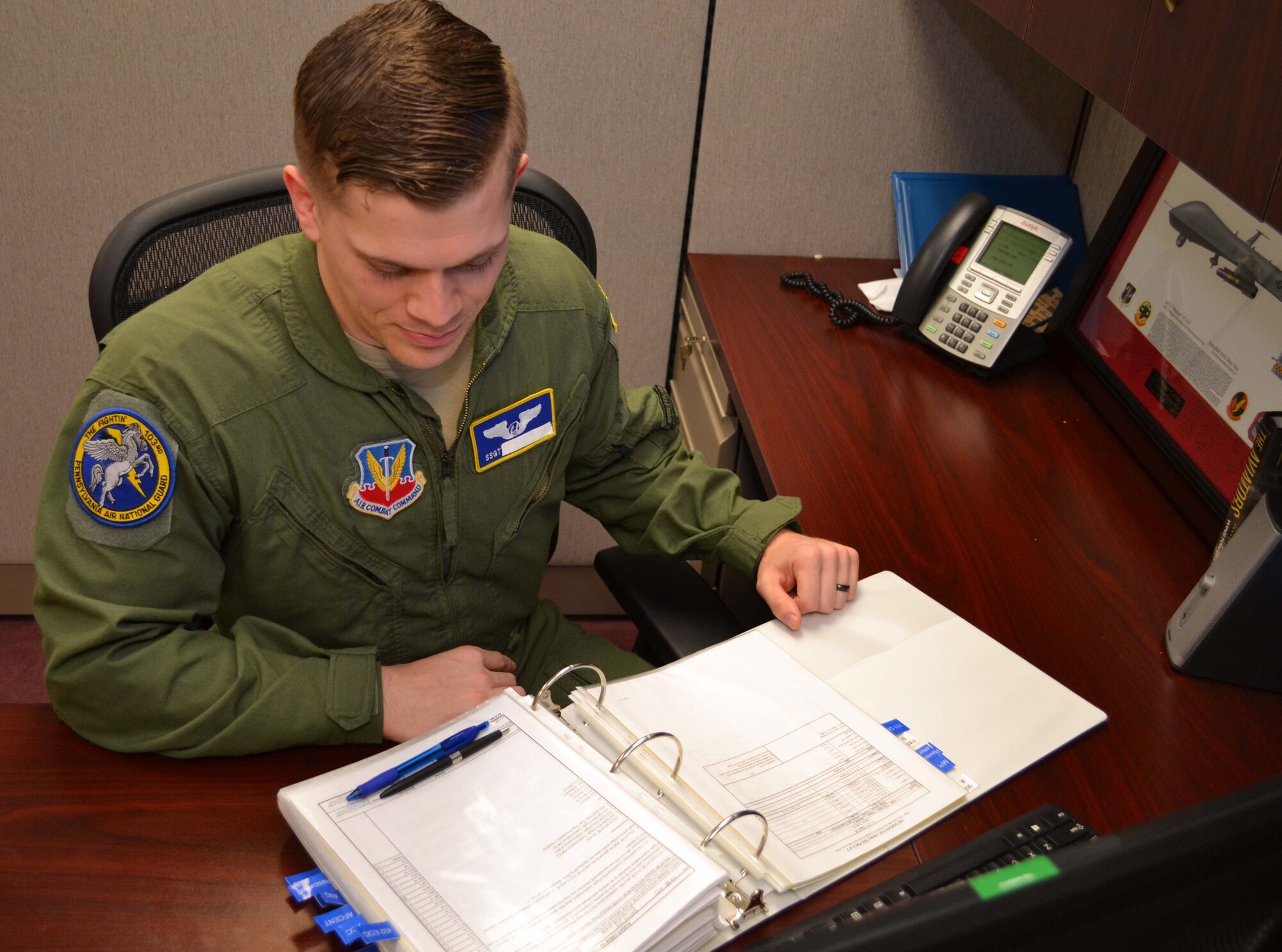 A sensor operator with the 111th Operations Group looks over a manual Jan. 27, 2016, in the 111th OG sensor operating section on Horsham Air Guard Station, Pennsylvania. Sensor operators play a critical role in the remotely-piloted aircraft mission at Horsham AGS, where the 111th Attack Wing operates the MQ-9 Reaper. (U.S. Air National Guard photo by Tech. Sgt. Andria Allmond)