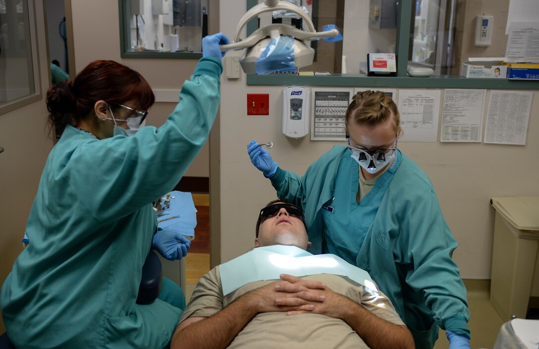 Jessica Arroyo (left), 22nd Aerospace Medicine Squadron dental assistant, and Capt. Jenna Chase, 22nd AMDS general dentist, set up for a cavity-filling procedure on a patient, Jan. 27, 2016, at McConnell Air Force Base, Kan. The 22nd AMDS dentists and technicians provide a full range of dental services to including examinations, cleanings, general dentistry, periodontics, endodontics, and oral surgery. (U.S. Air Force photo/Senior Airman Colby L. Hardin)