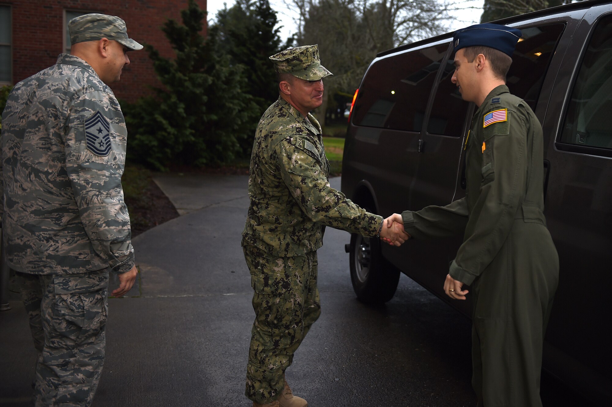 Fleet Master Chief, Terrence I. Molidor, command senior enlisted leader, North American Aerospace Defense Command and U.S. Northern Command, greets U.S. Air Force Capt. Ben Schaftel (right), 62nd Airlift Wing chief of protocol, and Chief Master Sgt. Zaki Mazid, 62nd AW command chief, at the 62nd AW headquarters building at Joint Base Lewis-McChord, Wash., Jan. 27, 2016. Molidor is visiting several units at various sites in the Pacific Northwest. He is responsible for mentoring senior enlisted leaders throughout the component commands (U.S. Air Force by/Senior Airman Naomi Shipley)