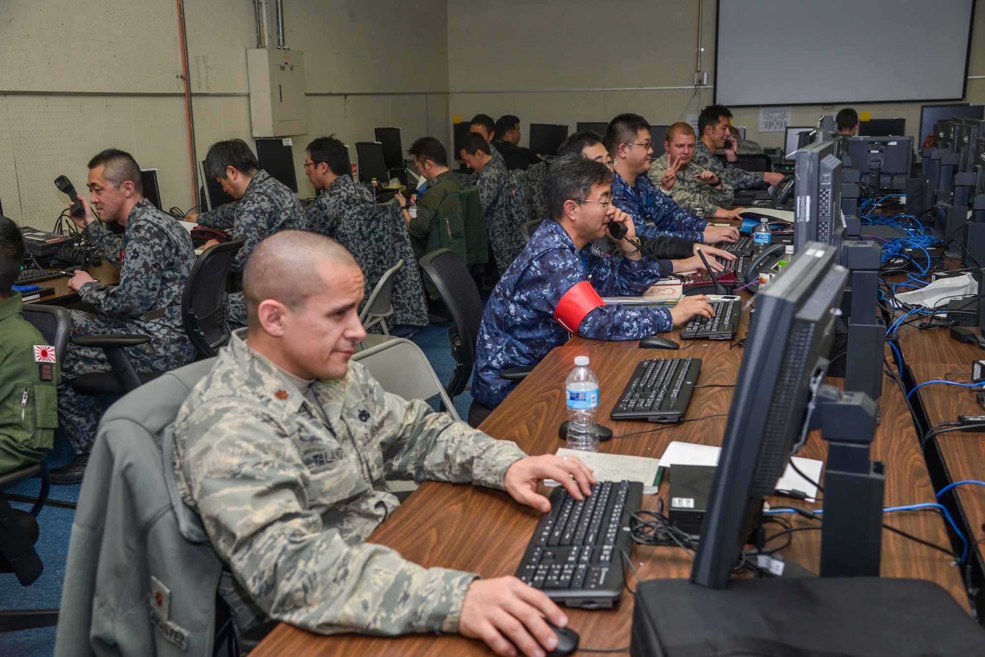 Japan Self-Defense Force and United States military members work on a scenario during the Keen Edge 16 exercise at Yokota Air Base, Japan, Jan. 21, 2016. The exercise focused on bilateral coordination, force protection, host nation support, ballistic missile defense and non-combatant evacuation operations in Japan. (U.S. Air Force photo by Senior Airman David Owsianka/Released)