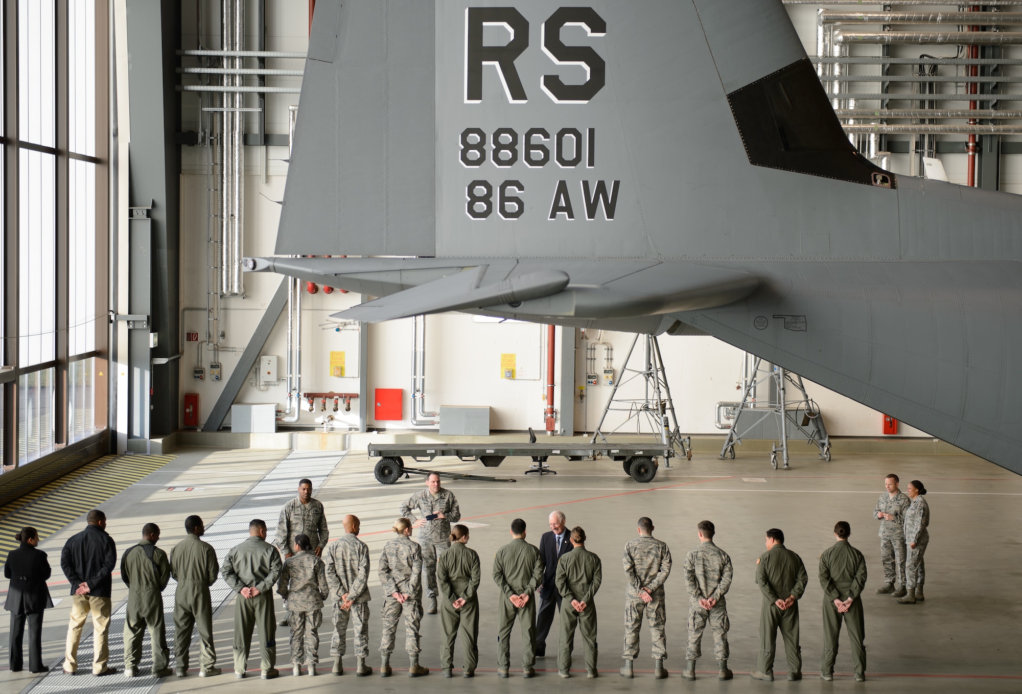 Members of the 86th Airlift Wing speak with Sam E. Parish, retired Chief Master Sergeant of the Air Force, after showcasing their mission and the C-130J Super Hercules Jan. 26, 2016, at Ramstein Air Base, Germany. Parish spent a week learning about the Airmen of Ramstein and completed his visit by guest speaking at the Chief Recognition Ceremony. The Airmen of the 86th showed Parish how they generate and employ air mobility enabling theater and strategic airpower by operating a key Air Force power projection platform at Ramstein.  (U.S. Air Force photo/Staff Sgt. Armando A. Schwier-Morales)