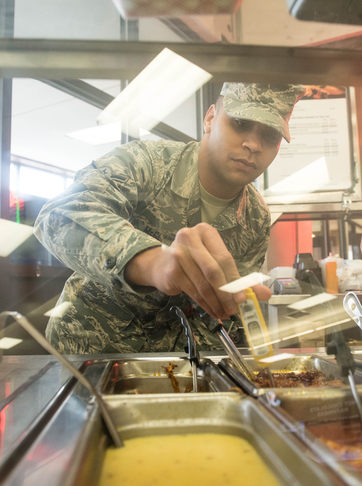 Airman Donte McClain, Public Health technician, checks the temperature of food prepared by a vendor during a routine inspection at Hanscom Air Force Base, Mass., Jan. 26. Throughout the week, 66th Medical Squadron personnel observed Biomedical Sciences Corps career fields. Hanscom BSC personnel support local active duty members and approximately 130,000 retired military personnel, annuitants and spouses living in the six-state New England region and New York. (U.S. Air Force photo by Jerry Saslav)