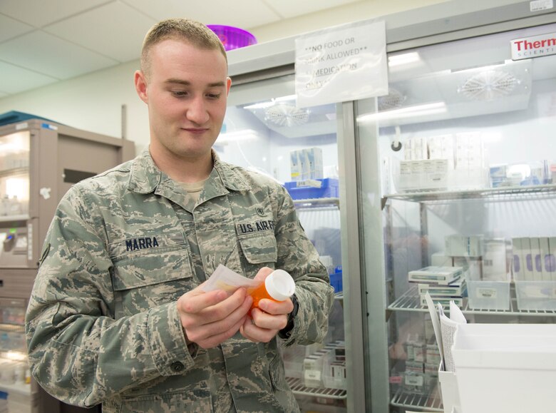 Airman 1st Class Matthew Marra, Pharmacy technician, places a label on a prescription at Hanscom Air Force Base, Mass., Jan. 26. In observance of Biomedical Sciences Corps Appreciation Week, the clinic is celebrating both clinical and non-clinical BSC career fields January 25 through 29. (U.S. Air Force photo by Jerry Saslav)