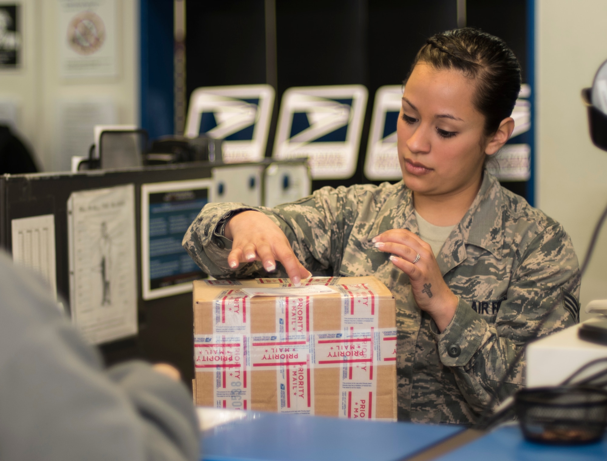 U.S. Air Force Senior Airman Maria Steelman, a postal clerk with the 35th Communications Squadron, labels a package at Misawa Air Base, Japan, Jan. 27, 2016. Steelman’s daily job consists of processing outgoing mail for customers and ensuring each customer’s individual needs are met. (U.S. Air Force photo by U.S. Air Force photo by Senior Airman Brittany A. Chase)