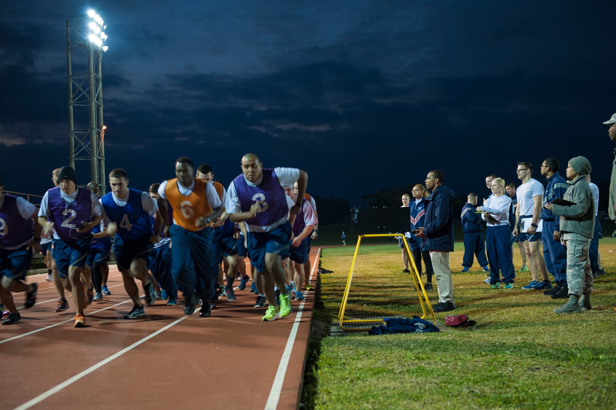 U.S. Air Force Airmen begin their 1.5 mile run during a physical fitness test at the Risner Fitness Center, Jan. 27, 2016, at Kadena Air Base, Japan. Testers have weathered the cold during the below average temperatures that have affected Kadena. (U.S. Air Force photo by Airman Zackary A. Henry)