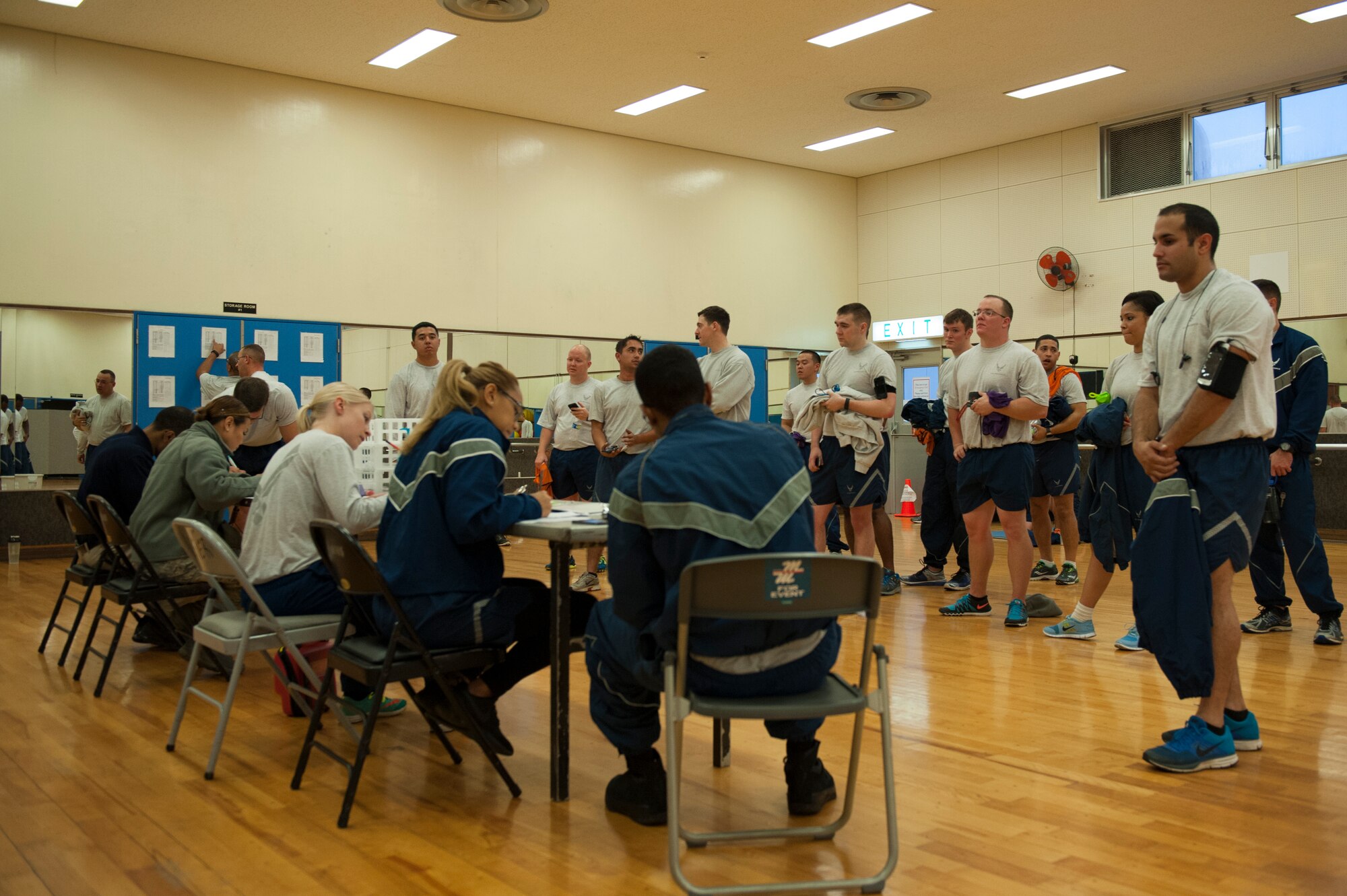 U.S. Air Force physical training leaders from the 18th Force Support Squadron score multiple Airmen’s physical fitness test scores at the Risner Fitness Center, Jan. 27, 2016, at Kadena Air Base, Japan. Despite temperatures reaching 10 degrees Fahrenheit lower than the average this time of year, physical fitness remains an important staple in the life of Kadena Airmen. (U.S. Air Force photo by Airman Zackary A. Henry)