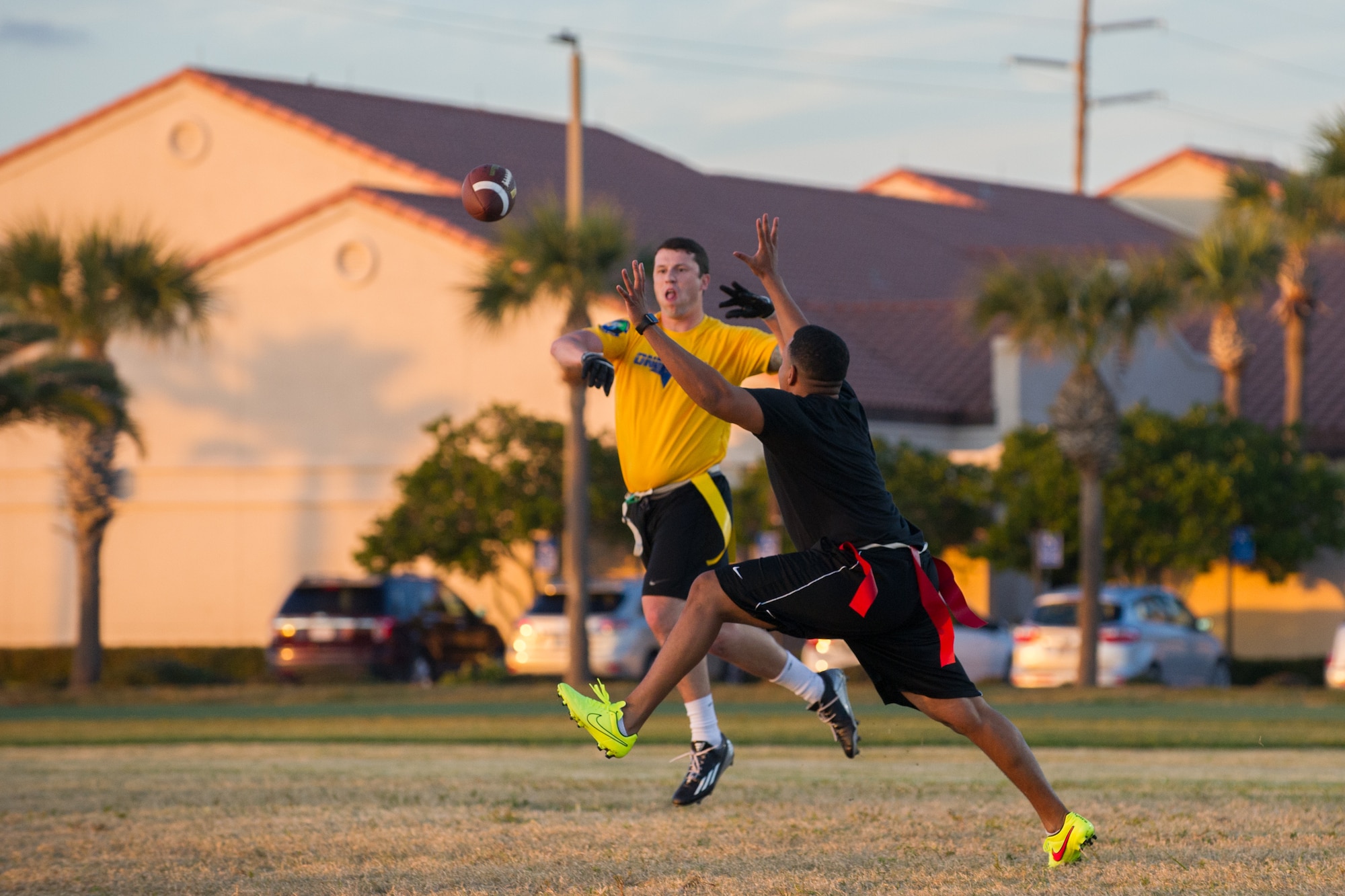 Intramural teams play a game of flag football, prior to a coin toss led by Brig. Gen. Wayne Monteith, 45th Space Wing commander, signifying the beginning of intramural football and re-introducing additional sports throughout the year Jan. 25, at Patrick Air Force Base, Fla. For more information about intramural sports and the Fitness and Sports Center, log onto www.gopatrickfl.com or call (321) 494-6697. (U.S. Air Force photos/Benjamin Thacker) (Released) 
