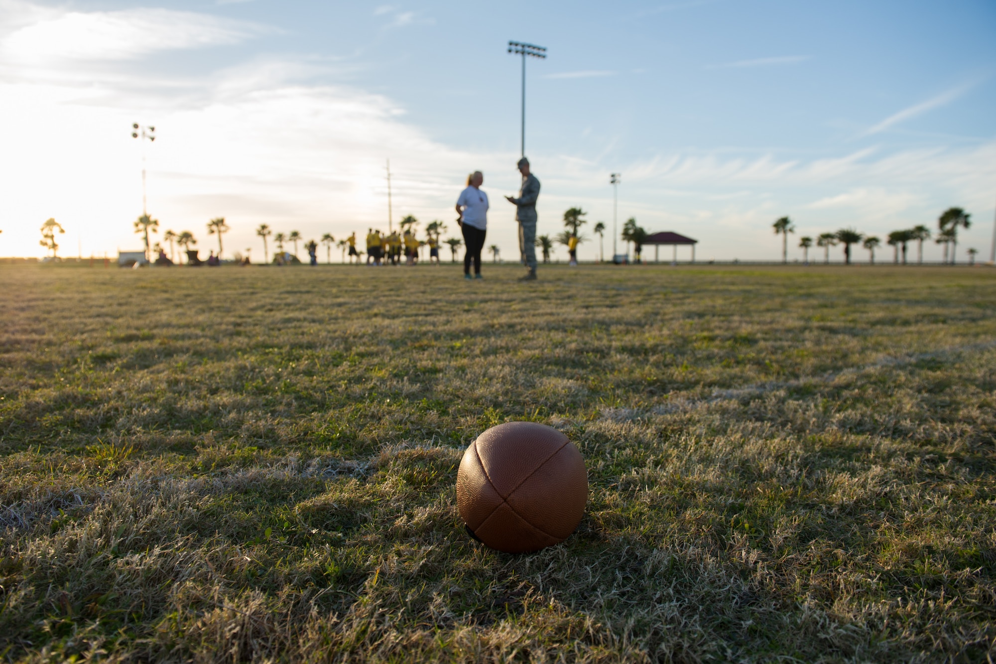 Intramural teams play a game of flag football, prior to a coin toss led by Brig. Gen. Wayne Monteith, 45th Space Wing commander, signifying the beginning of intramural football and re-introducing additional sports throughout the year Jan. 25, at Patrick Air Force Base, Fla. For more information about intramural sports and the Fitness and Sports Center, log onto www.gopatrickfl.com or call (321) 494-6697. (U.S. Air Force photos/Benjamin Thacker) (Released) 