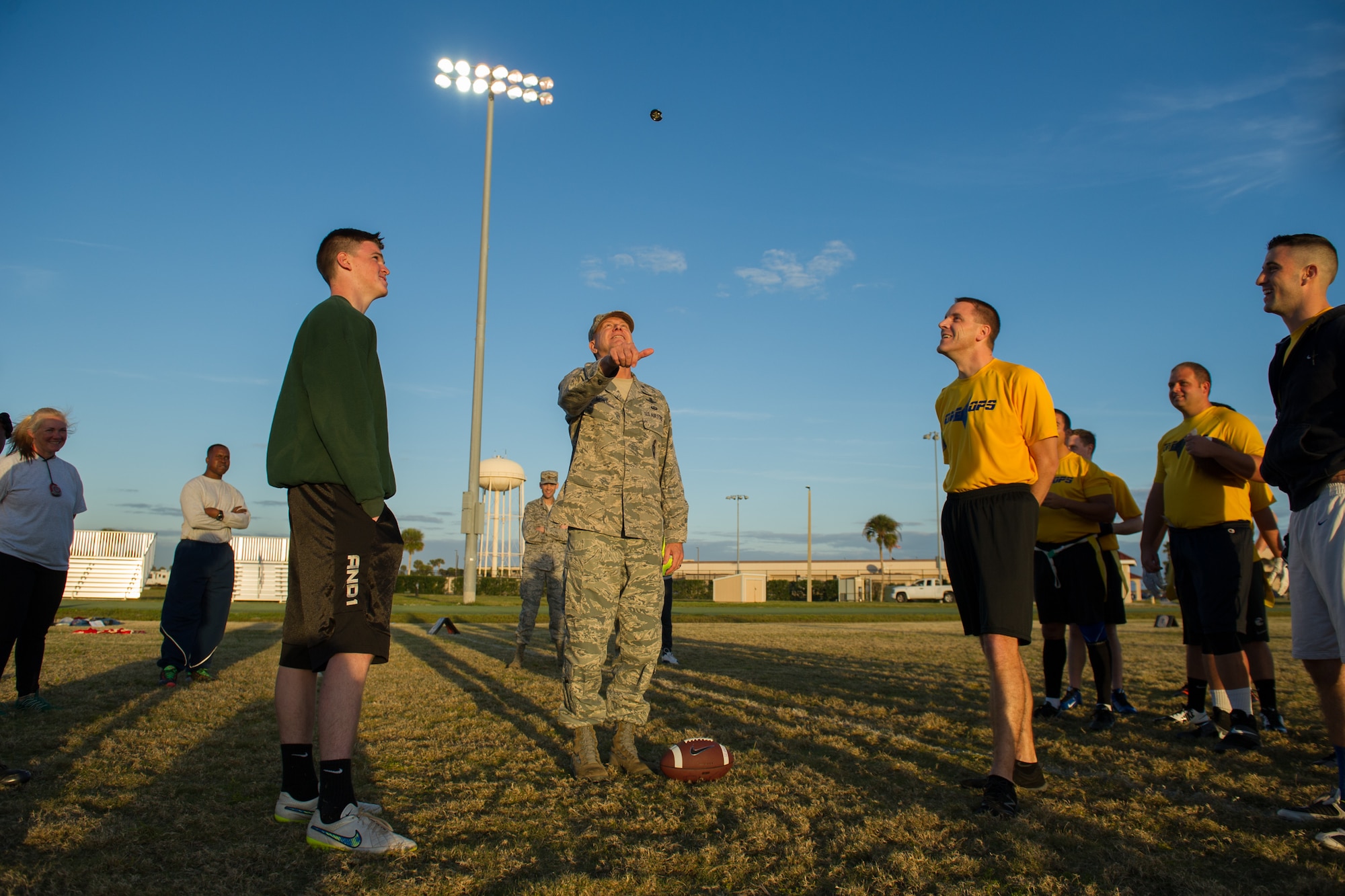 Intramural teams play a game of flag football, prior to a coin toss led by Brig. Gen. Wayne Monteith, 45th Space Wing commander, signifying the beginning of intramural football and re-introducing additional sports throughout the year Jan. 25, at Patrick Air Force Base, Fla. For more information about intramural sports and the Fitness and Sports Center, log onto www.gopatrickfl.com or call (321) 494-6697. (U.S. Air Force photos/Benjamin Thacker) (Released) 