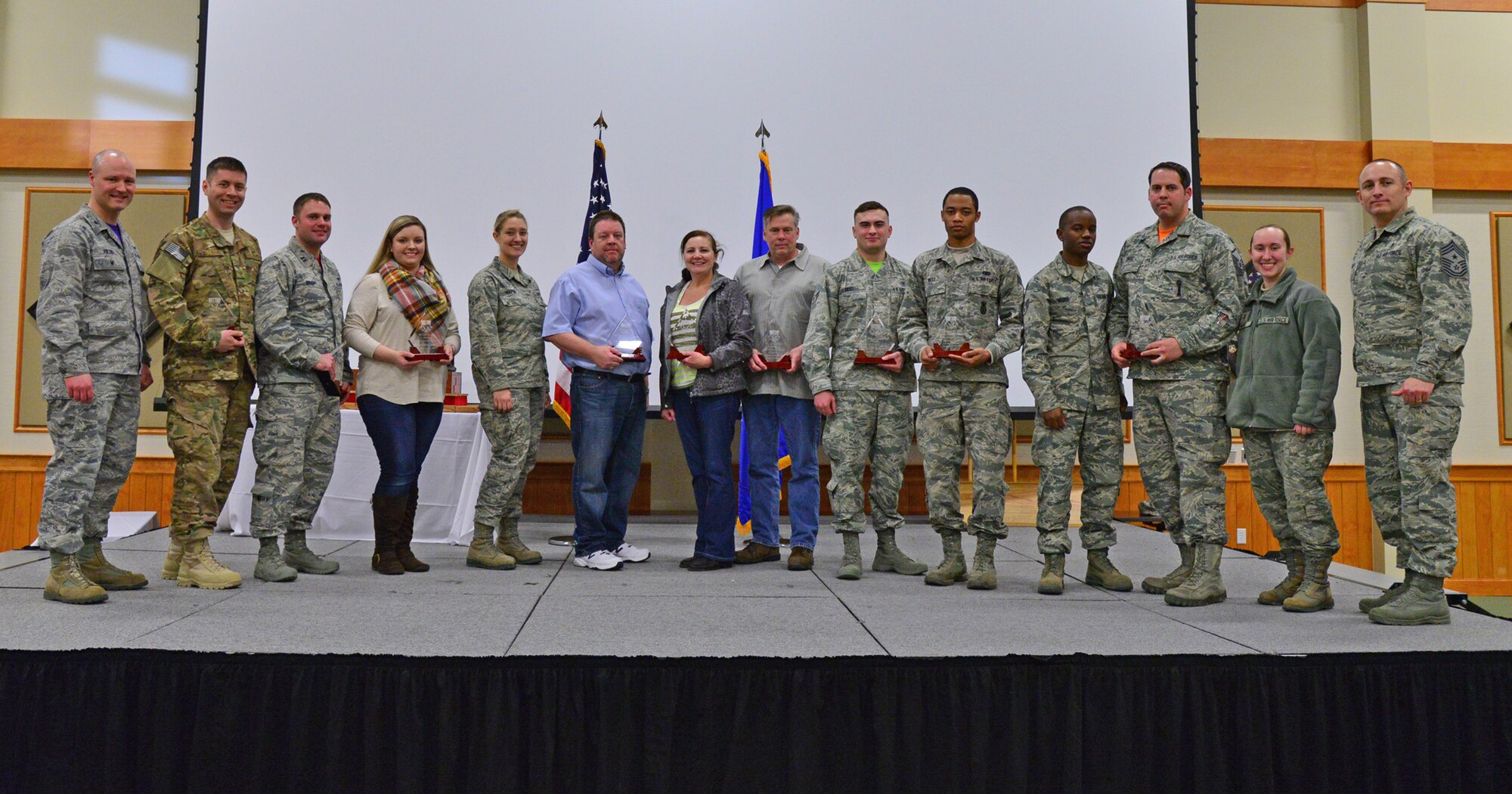 Winners of the fourth quarter Wing Quarterly Awards pose for a photo at the Grizzly Bend Jan. 22, 2016. Pictured from left to right are: Col. Jay Folds, 341st Missile Wing vice commander; NCO of the Quarter, Tech. Sgt. Paul Wilson, 341st Mission Support Group; Company Grade Officer of the Quarter Capt. Jacob Bright, 819th RED HORSE Squadron; Spouse of the Quarter, Liz Arrexi, 341st Security Forces Group; Dormitory of the Quarter accepted by Airman 1st Class Ashley Kapski, 341 Missile Maintenance Squadron; Civilian Category I Supervisory, Kenneth Sanders, 341st MSG; Civilian Category II Supervisory, Mercy Padgett, 341st Medical Group; Civilian Category I, Greg Brown, 341st MDG; Airman of the Quarter, Airman 1st Class Cody Best, 341st MDG; Honor Guard of the Quarter, Senior Airman Deanthony West, 341st SFG; Professional Team of the Quarter, Senior Airman Jamal Moss, Master Sgt. Kurt Dodd, 2nd Lt. Caitlin Ward, 341st MMXS; Chief Master Sgt. Thomas Stiles, 341st MW command chief. Not pictured are: Volunteer of the Quarter, Senior Airman Dane Swanger, 341st MSG; Senior NCO of the Quarter, Master Sgt. Russell Tripi, 341st SFG; Civilian Category II, David Decker, 341st Operations Group. (U.S. Air Force photo/Airman Daniel Brosam)