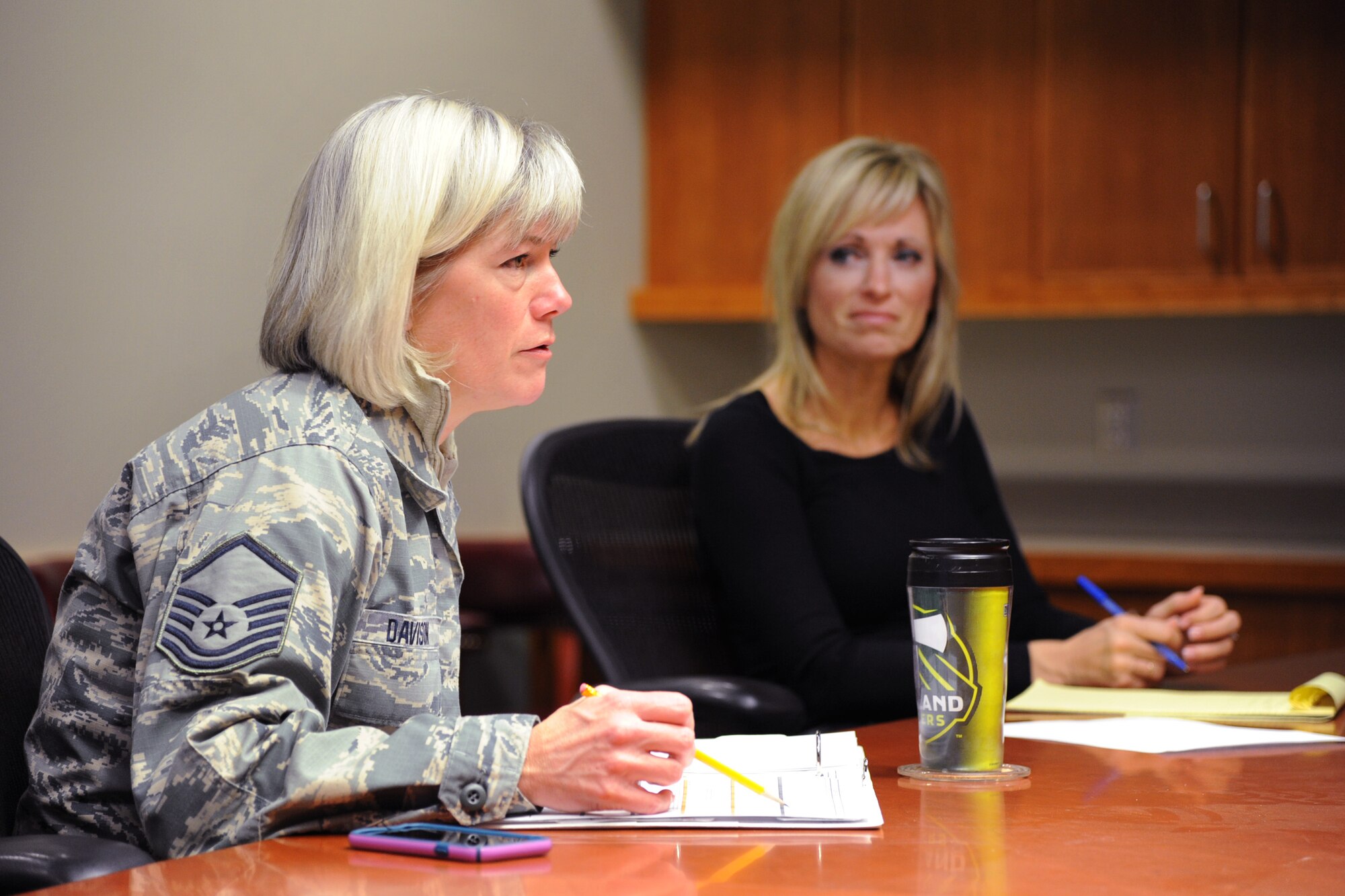 Oregon Air National Guard Master Sgt. Shelly Davison, a public affairs specialist, left, and DeAnn Smetana, Director of Psychological Health, assigned to the 142nd Fighter Wing Headquarters, discuss upcoming classes and activates during a Comprehensive Airman Fitness working group meeting, Jan. 21, 2016, Portland Air National Guard Base, Ore. The 142nd Fighter Wing began 2016 with a new series of courses and activities under the Comprehensive Airmen Fitness program, designed to focus on Airmen and their families' physical, social, mental and spiritual wellness. (U.S. Air National Guard photo by Tech. Sgt. John Hughel, 142nd Fighter Wing Public Affairs/released)