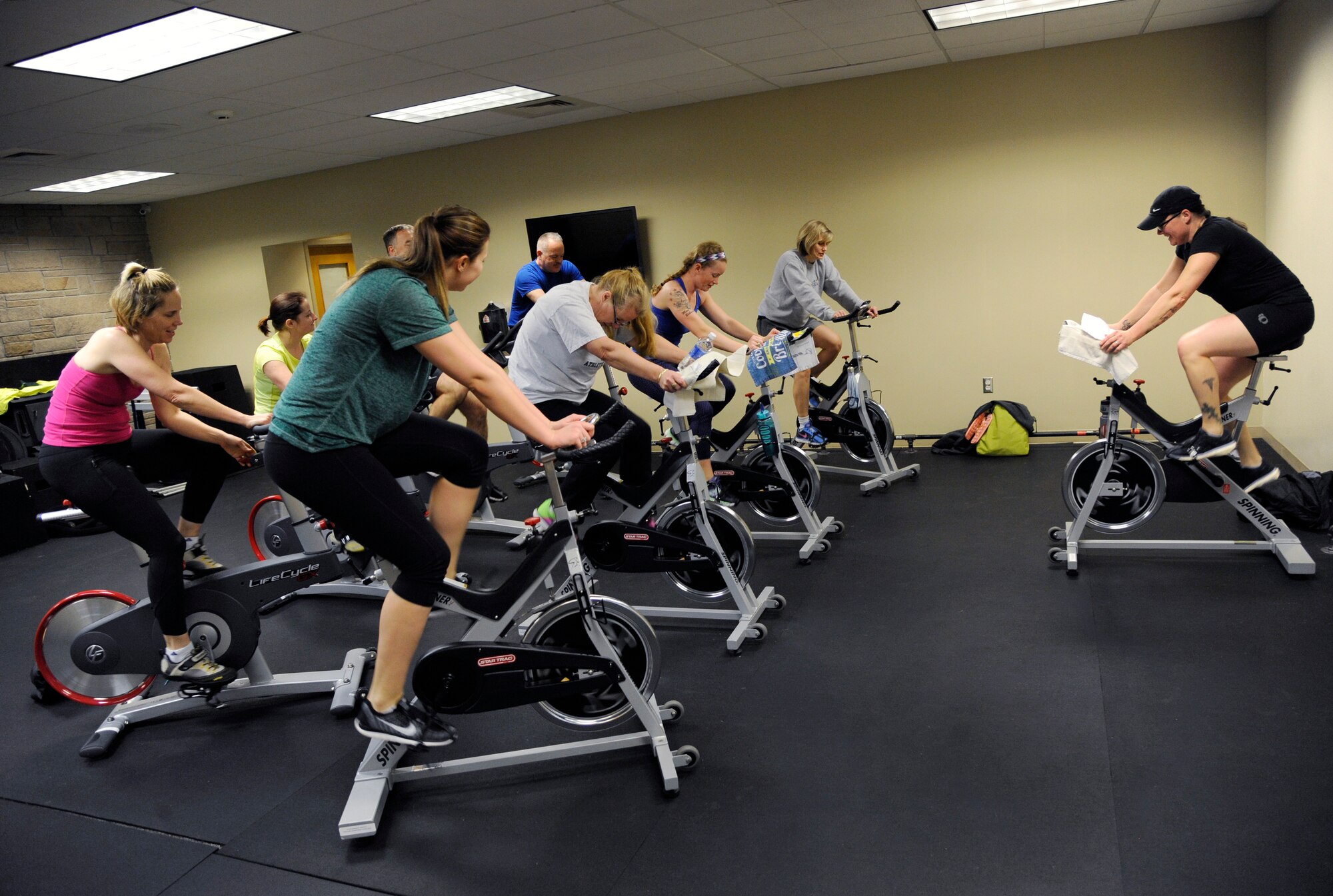 Oregon Air National Guard Senior Master Sgt. Bobbi Kennedy, a health service technician assigned to the 142nd Fighter Wing Medical Group, right, teaches a morning spin class at the base gym, Jan. 28, 2016, Portland Air National Guard Base, Ore. The 142nd Fighter Wing began 2016 with a new series of courses and activities under the Comprehensive Airmen Fitness program, designed to focus on Airmen and their families' physical, social, mental and spiritual wellness. (U.S. Air National Guard photo by Tech. Sgt. John Hughel, 142nd Fighter Wing Public Affairs/released)
