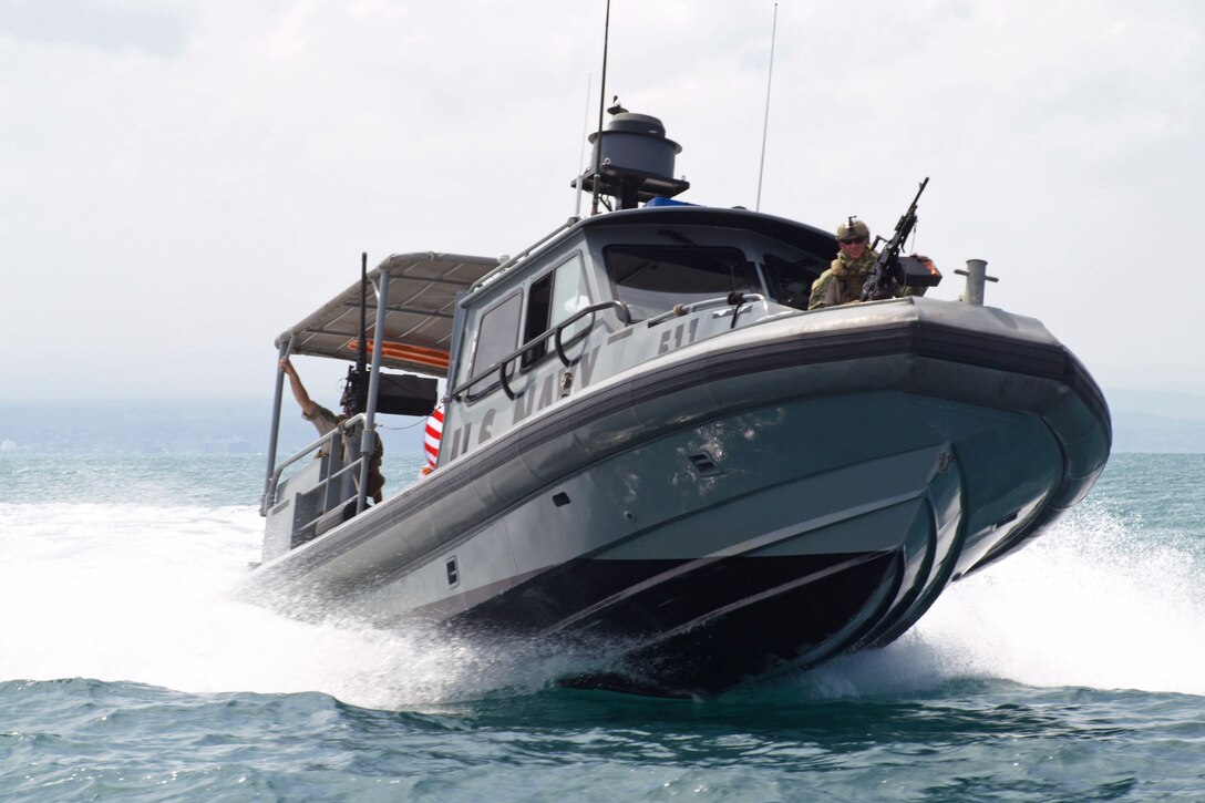 U.S. Navy Petty Officer 2nd Class Dustin Burton mans a crew-served weapon aboard a patrol boat in the Gulf of Tadjoura, Djibouti, Jan. 28, 2016. Burton is assigned to Coastal Riverine Squadron 10. U.S. 6th Fleet conducts operations with allies and partners to advance U.S. national interests and maintain security and stability in Europe and Africa. Navy photo by Petty Officer 2nd Class Perry Lafoe