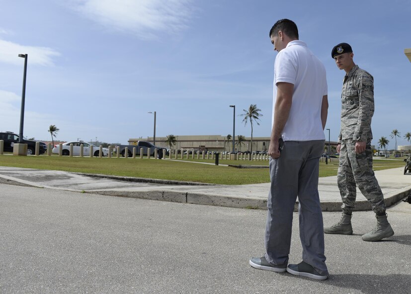 Airman Austin Bauer, 36th Security Forces Squadron, right, watches a volunteer perform a walk and turn test during field sobriety test training Jan. 29, 2016, at Andersen Air Force Base, Guam. This test challenges an individual's short-term memory, balance and motor skills, which are needed for safe operation of a vehicle. (U.S. Air Force photo/Airman 1st Class Jacob Skovo)