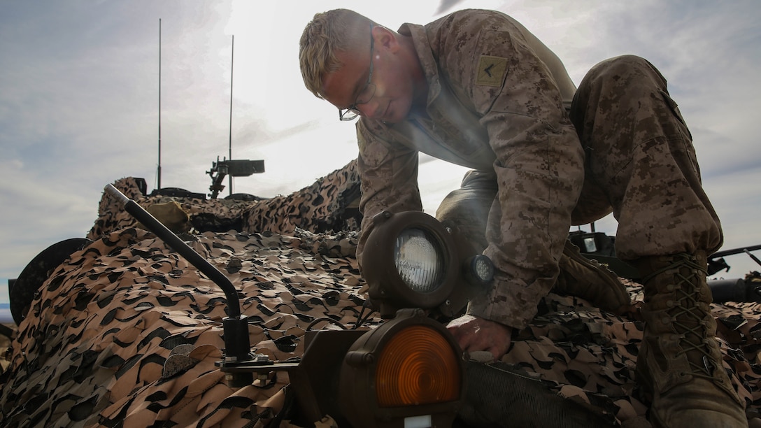 Pfc. Merrick Martius, a Light Armored Vehicle crewman, provides maintenance for an infrared light on an LAV-25 during a live-fire gunnery qualification test at Marine Corps Air Ground Combat Center Twentynine Palms,California, Jan. 22, 2016. The qualification test consisted of gunnery training, communication between the vehicle commander and the driver, and cooperation between the crewmembers of the LAV and the command tower. This allows Marines to fire accurately when aiming on targets down range. Martius is an LAV crewman with Headquarters and Service Company, 1st Marine Division, I Marine Expeditionary Force. 