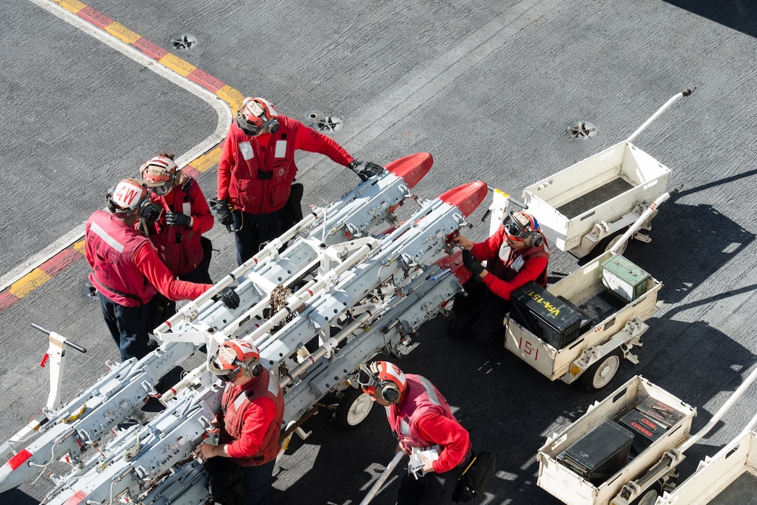 Sailors adjust settings on a BRU-41 ejector rack on the flight deck of the USS John C. Stennis in the Pacific Ocean, Jan. 28, 2016. Providing a combat-ready force to protect collective maritime interests, Stennis is operating as part of the Great Green Fleet on a regularly scheduled Western Pacific deployment. Navy photo by Seaman Tomas Compian