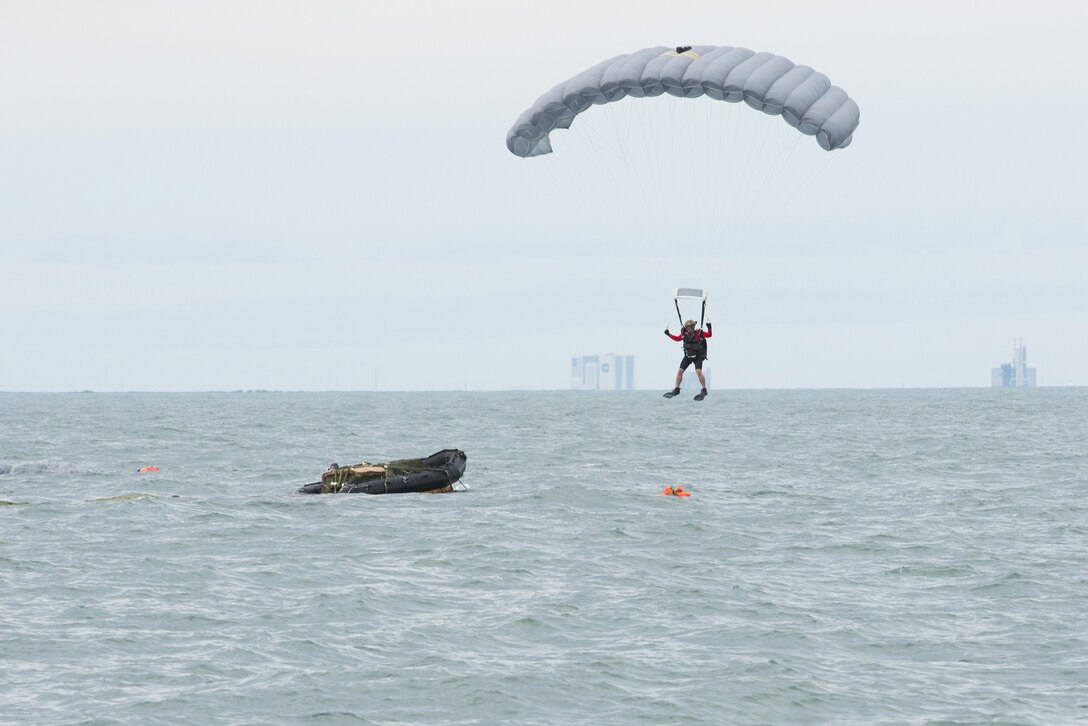 An Air Force Reserve pararescueman descends into the Atlantic Ocean from a C‐17 Globemaster III in an effort to recover a NASA astronaut as part of an exercise Jan. 14, 2016, off the shore of Cape Canaveral Air Force Station, Fla. The 45th Operations Group’s Detachment 3 joined NASA's Commercial Crew Program; Air Force pararescuemen; combat rescue officers; and survival, evasion, resistance and escape specialists to practice recovering astronauts quickly and safely in the event they would need to abandon their spacecraft. (U.S Air Force photo/Matthew Jurgens)