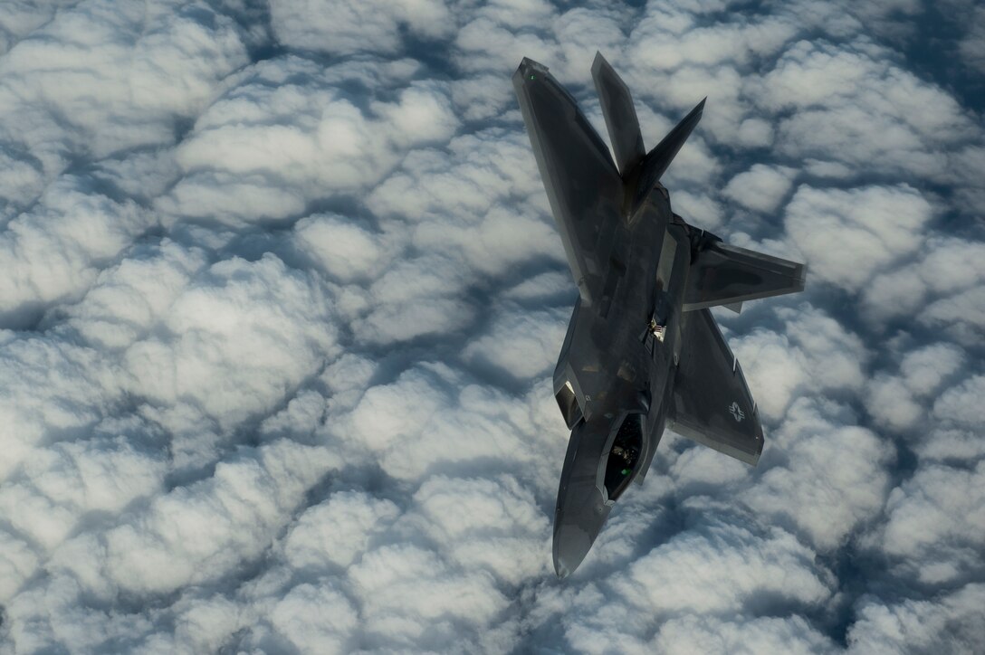 An Air Force F-22 Raptor flies over the Arabian Sea in support of Operation Inherent Resolve, Jan. 27, 2016. Air Force photo by Staff Sgt. Corey Hook