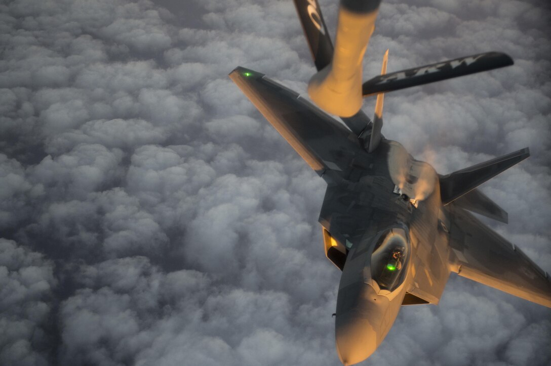 An Air Force F-22 Raptor descends after receiving fuel from a KC-135 Stratotanker over the Arabian Sea in support of Operation Inherent Resolve, Jan. 27, 2016. Air Force photo by Staff Sgt. Corey Hook