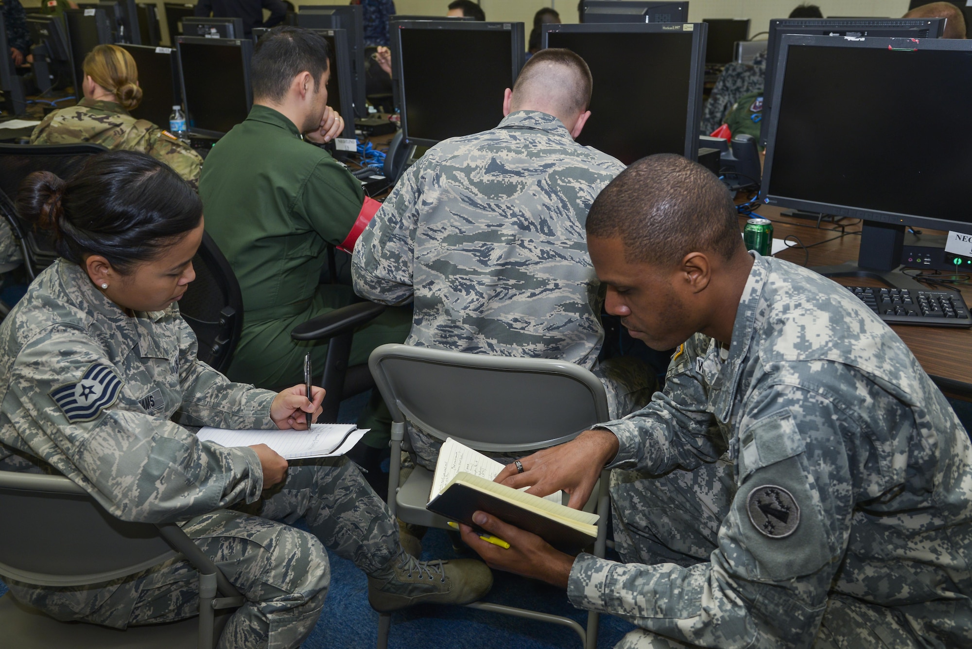 Japan Self-Defense Force and U.S. military members work on a scenario during exercise Keen Edge 16 at Yokota Air Base, Japan, Jan. 21, 2016. The exercise focused on bilateral coordination, force protection, host nation support, ballistic missile defense and non-combatant evacuation operations in Japan. (U.S. Air Force photo/Senior Airman David Owsianka)