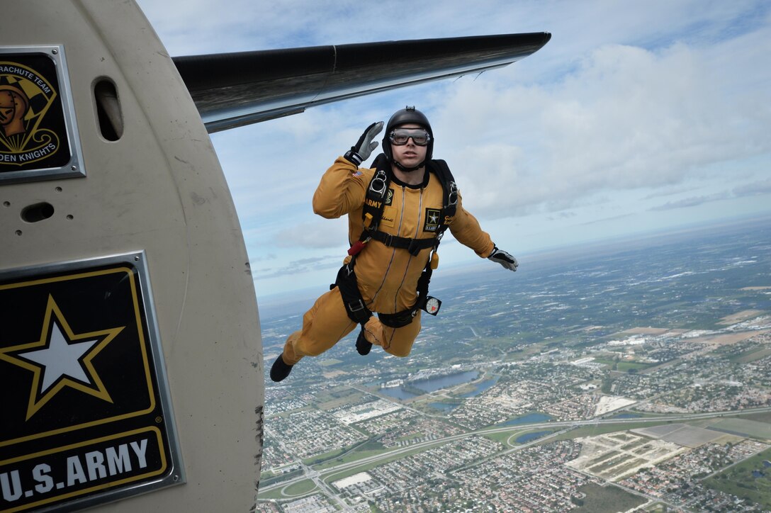 Army Sgt. Dustin Gebhardt, a member of the Golden Knights demonstration team, salutes as he exits a Fokker C-31A troopship during a training jump over Homestead Air Reserve Base, Fla., Jan. 21, 2016. New York Air National Guard photo by Staff Sgt. Christopher S. Muncy