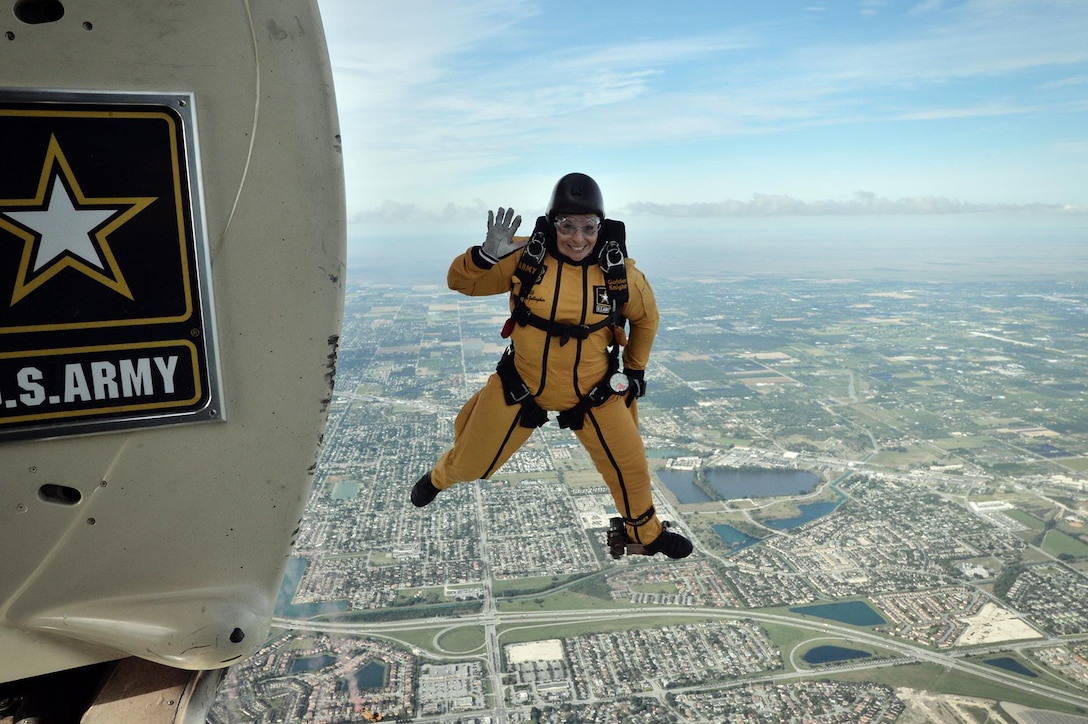 Army Staff Sgt. Sherri Jo Gallagher, a member of the Golden Knights demonstration team, waves as she exits a Fokker C-31A troopship during a training jump over Homestead Air Reserve Base, Fla., Jan. 21, 2016. New York Air National Guard photo by Staff Sgt. Christopher S. Muncy