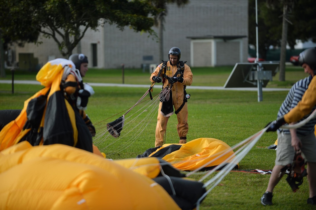 Members of the Army's Golden Knights demonstration team recover their parachutes after conducting a training jump over Homestead Air Reserve Base, Fla., Jan. 21, 2016. New York Air National Guard photo by Staff Sgt. Christopher S. Muncy