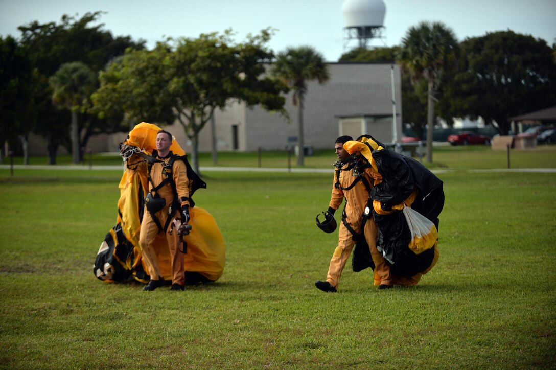 Members of the Army's Golden Knights demonstration team collect their parachutes after conducting a training jump over Homestead Air Reserve Base, Fla., Jan. 21, 2016. New York Air National Guard photo by Staff Sgt. Christopher S. Muncy