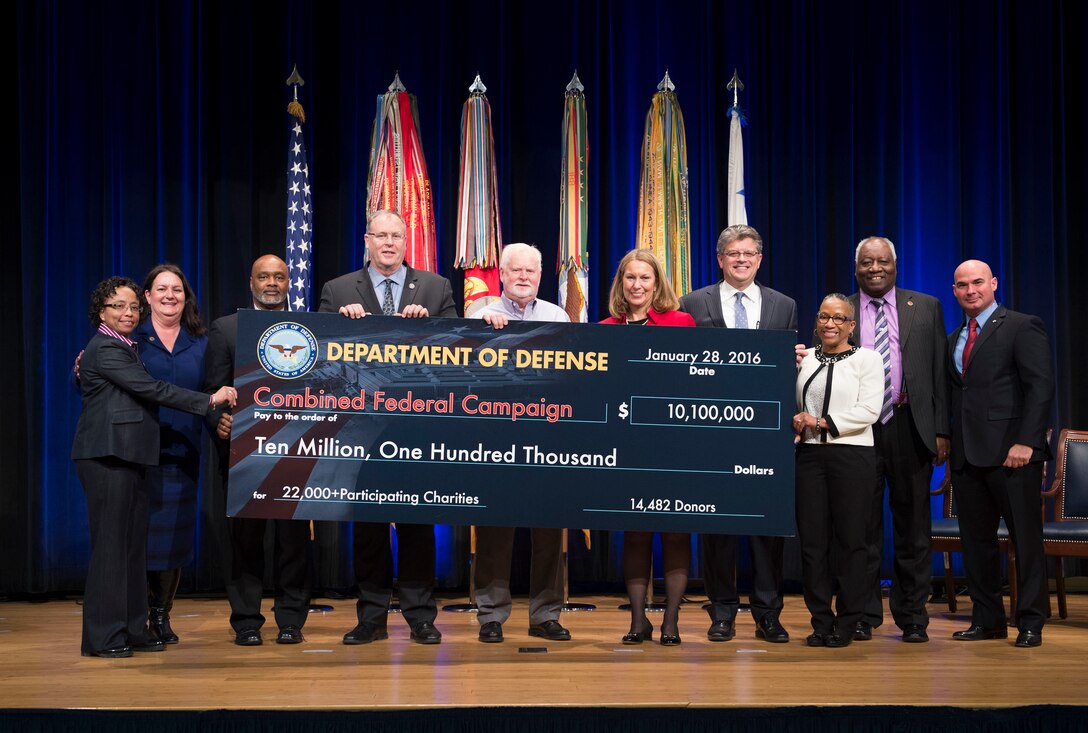 Deputy Defense Secretary Bob Work, fourth from left, presents a representation of a check of donated funds at the Combined Federal Campaign awards ceremony at the Pentagon, Jan. 28, 2016. The campaign is the world's largest annual workplace charity effort. DoD photo by Navy Petty Officer 1st Class Tim D. Godbee