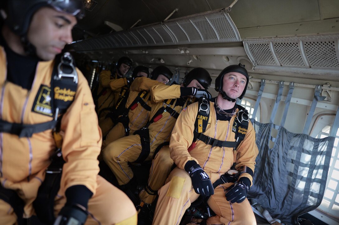 Members of the Army's Golden Knights demonstration team check their teammate's parachutes before conducting a training jump over Homestead Air Reserve Base, Fla., Jan. 21, 2016. New York Air National Guard photo by Staff Sgt. Christopher S. Muncy