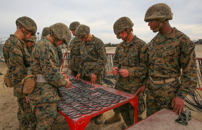 Private Toosaint P. Mitchell, Lima Company, 3rd Recruit Training Battalion, participates in a working party during the rappel tower event at Marine Corps Recruit Depot San Diego, Jan. 22. The recruits who part of the working party were told to line up the equipment so the others could quickly grab them before tackling the event. Mitchell is afraid of heights, but he managed to complete the event along with the other recruits. Annually, more than 17,000 males recruited from the Western Recruiting Region are trained at MCRD San Diego.