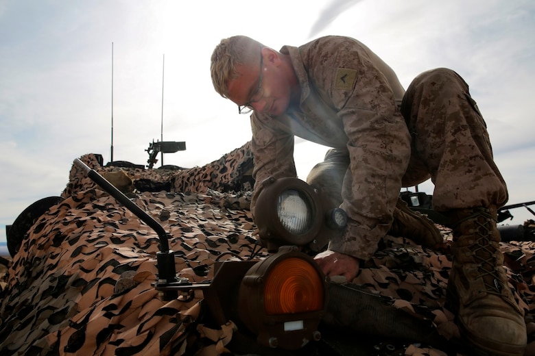 Pfc. Merrick Martius, a Light Armored Vehicle crewman, provides maintenance for an infrared light on an LAV-25 during a live-fire gunnery qualification test at Marine Corps Air Ground Combat Center Twentynine Palms, Jan. 22, 2016. The qualification test consisted of gunnery training, communication between the vehicle commander and the driver, and cooperation between the crewmembers of the LAV and the command tower. This allows Marines to fire accurately when aiming on targets down range. Martius is an LAV crewman with Headquarters and Service Company, 1st Marine Division, I Marine Expeditionary Force. (U.S. Marine Corps photo by Pvt. Robert Bliss)