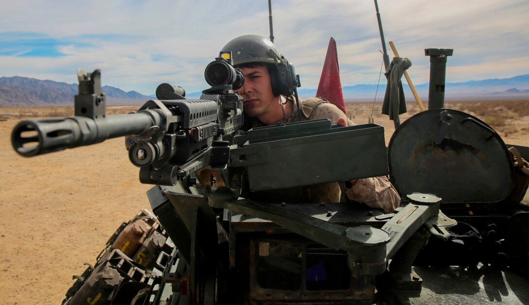 Sgt. Tyler Felts, an LAV crewman, sights in on a target during a live-fire gunnery qualification test with an M240B machine gun at Marine Corps Air Ground Combat Center Twentynine Palms, Jan. 22, 2016. Live-fire tests like these allow the Marines of 1st Light Armored Reconnaissance Battalion, 1st Marine Division, I Marine Expeditionary Force to train for how they will execute their mission when they are deployed in a combat zone. (U.S. Marine Corps photo by Pvt. Robert Bliss)