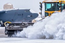 The 5th Civil Engineer Squadron removes snow from the flightline before a training sortie at Minot Air Force Base, N.D., Jan. 14, 2016. Bomber Airmen work around the clock in all weather conditions in order to provide B-52H Stratofortress firepower on demand. (U.S. Air Force photo/Airman 1st Class J.T. Armstrong)